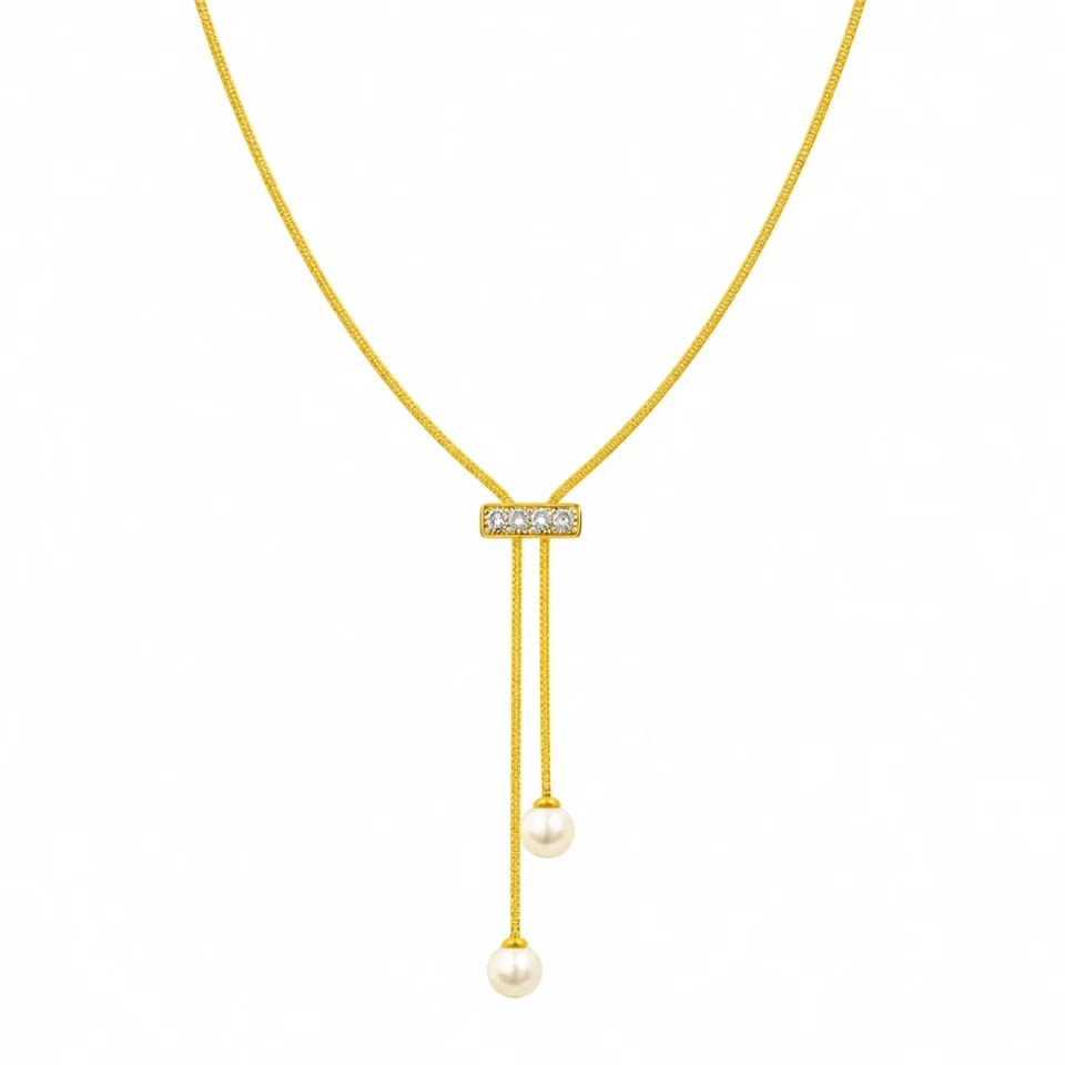 18K gold plated adjustable lariat necklace with a crystal bar slider and two pearl drops on a white background