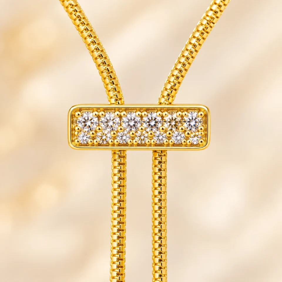 18K gold plated adjustable lariat necklace with a crystal bar slider and two pearl drops on a white background
