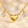 18K gold plated chain bracelet with three puffy heart charms and four bezel-set crystal drops, with lobster clasp and extender, on a white background