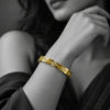 18K gold plated hinged bangle with a faceted quilted diamond pattern and three crystal clusters on a white background