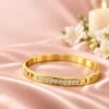 18K gold plated hinged bangle with a row of ten clear crystals and cut-out window details-Lifestyle