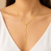 18K gold plated Y-shaped lariat necklace with polished bar stations on a fine curb chain and a three-bar drop, on a white background