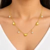 18K gold plated chain bracelet with three puffy heart charms and four bezel-set crystal drops, with lobster clasp and extender, on a white background