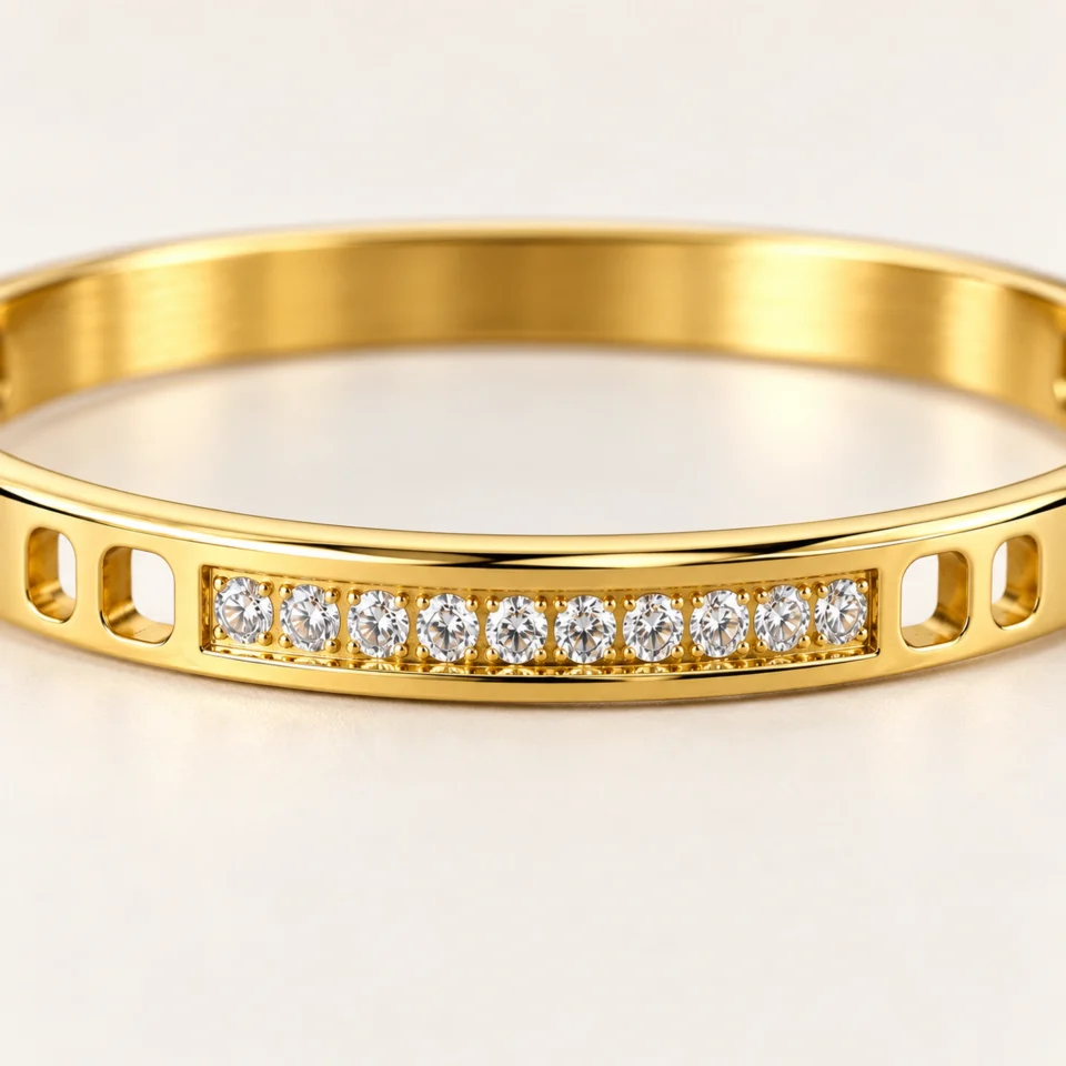18K gold plated hinged bangle with a row of ten clear crystals and cut-out window details