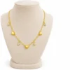 18K gold plated chain bracelet with three puffy heart charms and four bezel-set crystal drops, with lobster clasp and extender, on a white background