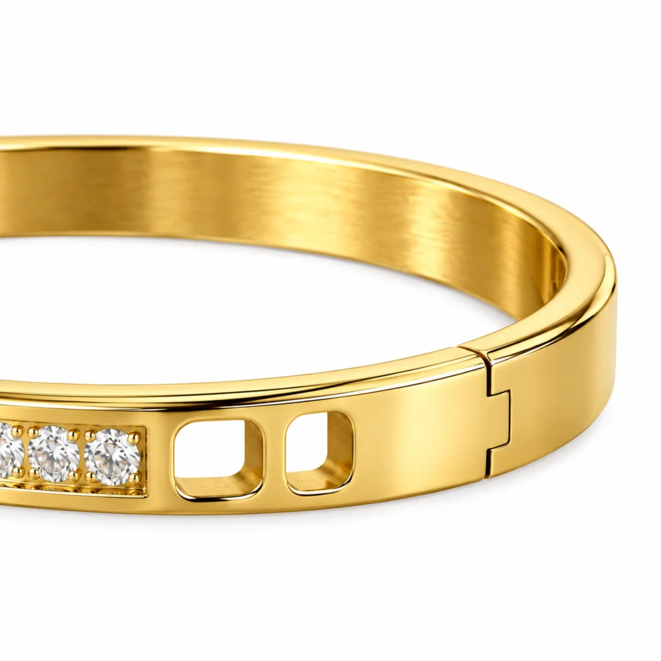18K gold plated hinged bangle with a row of ten clear crystals and cut-out window details