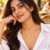 18K gold plated chain bracelet with three puffy heart charms and four bezel-set crystal drops, with lobster clasp and extender, on a white background