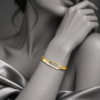 18K gold plated hinged crossover bangle with a bar of clear crystals overlapping a mother-of-pearl inlay - stylish photoshoot