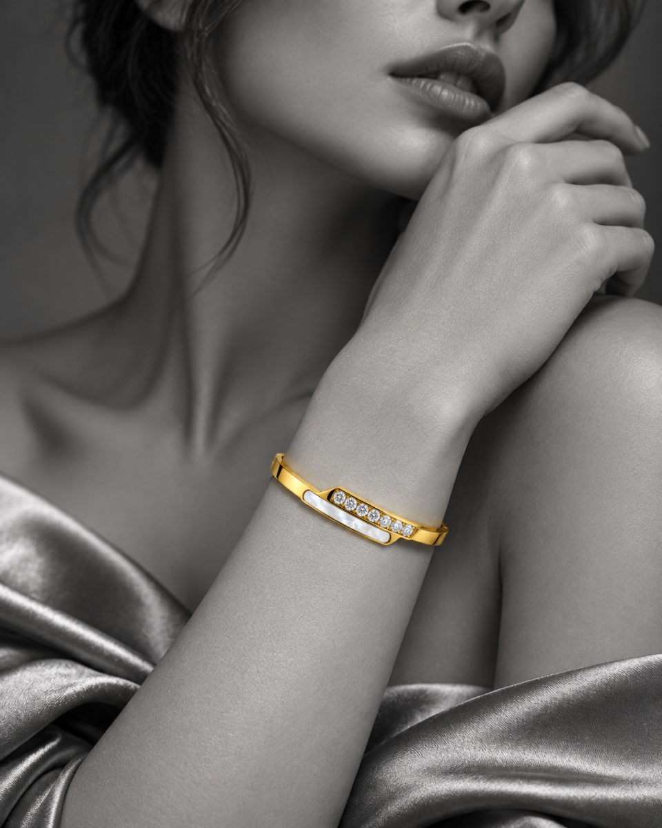 18K gold plated hinged crossover bangle with a bar of clear crystals overlapping a mother-of-pearl inlay - stylish photoshoot